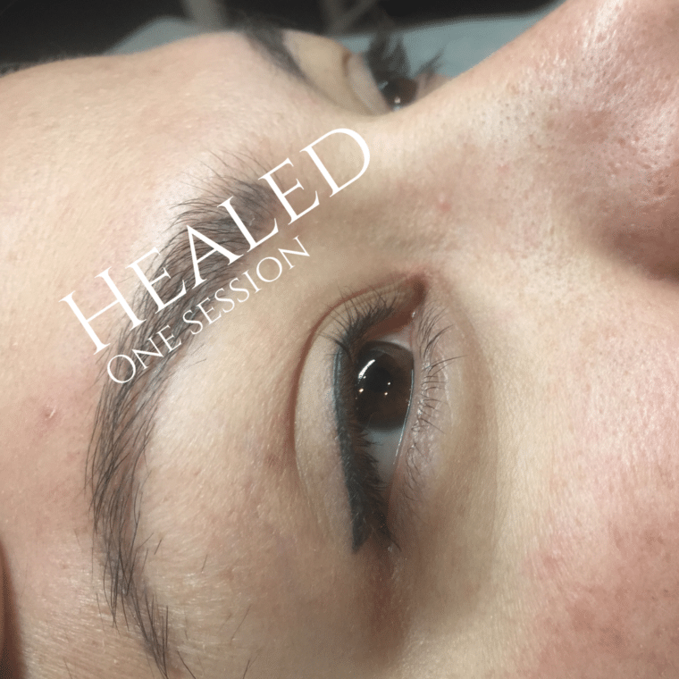 Close-up of an eye showing healed permanent makeup for the eyebrow and a dark eyeliner, with text 'HEALED ONE SESSION'.